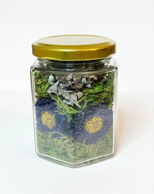 Dried Purple Asters with Seeded Eucalyptus in Honeycomb Shaped Glass Jar with Gold Lid